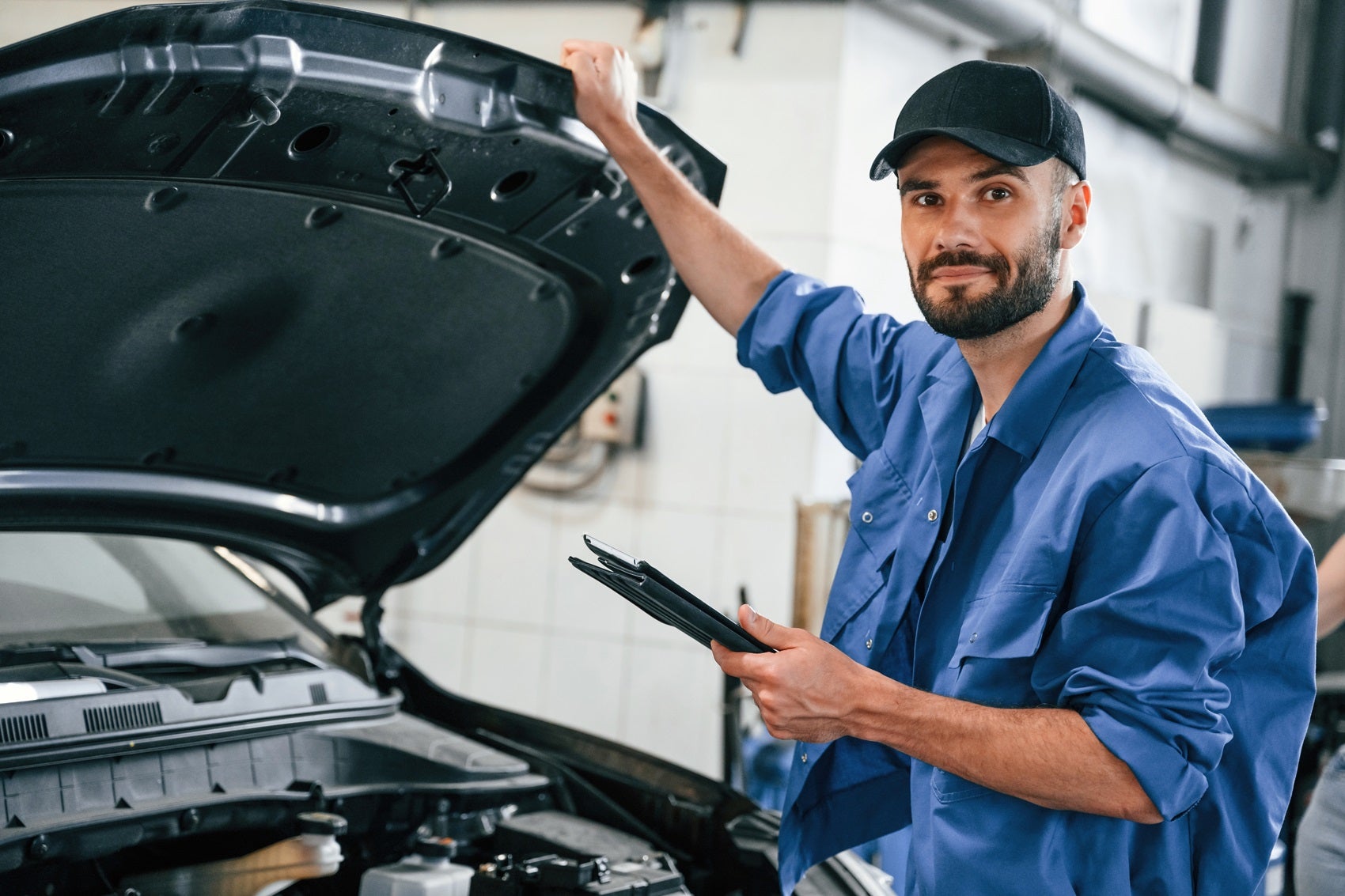 Hyundai Service Technician Smiling During a Vehicle Inspection